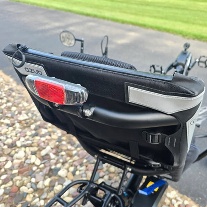 Closeup view of the seat back and taillight on the Azub Demo Ti-Fly 26 Shimano EP6 Deep Black Recumbent Trike in an outdoor setting.