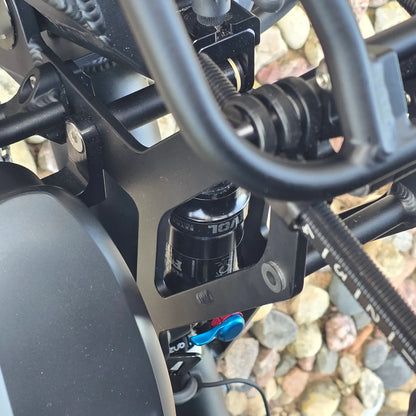 Closeup view of the Fox Float rear shock on the Azub Demo Ti-Fly 26 Shimano EP6 Deep Black Recumbent Trike in an outdoor setting.