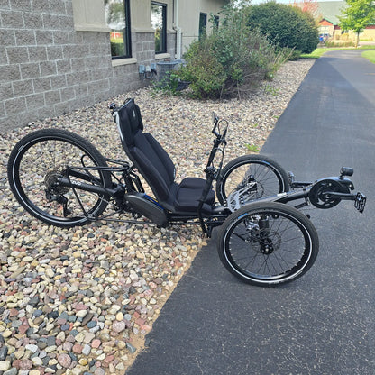 Side view of the Azub Demo Ti-Fly 26 Shimano EP6 Deep Black Recumbent Trike in an outdoor setting.