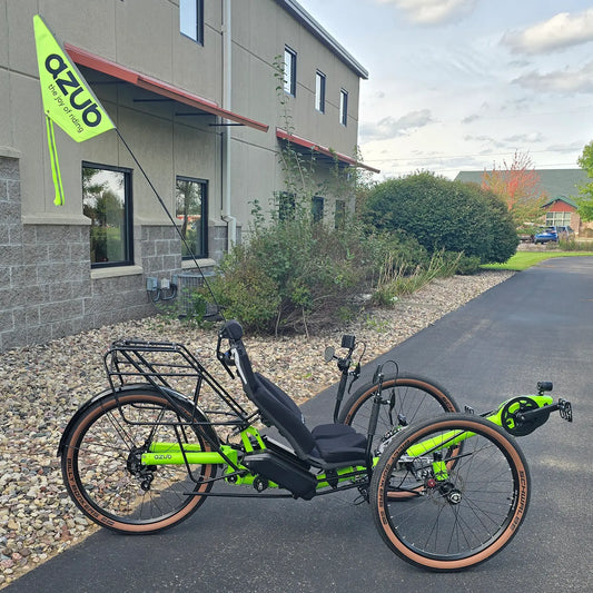 Side view of the Azub Demo Ti-Fly X Rohloff E14 Bosch Performance CX Dual Battery Lime Green Recumbent Trike in an outdoor setting.