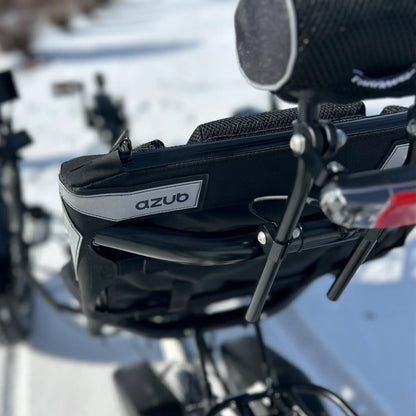 Closeup of the rear of the seat and neck rest on the Azub Limited Edition Ti-Fly recumbent trike on a snowy path.