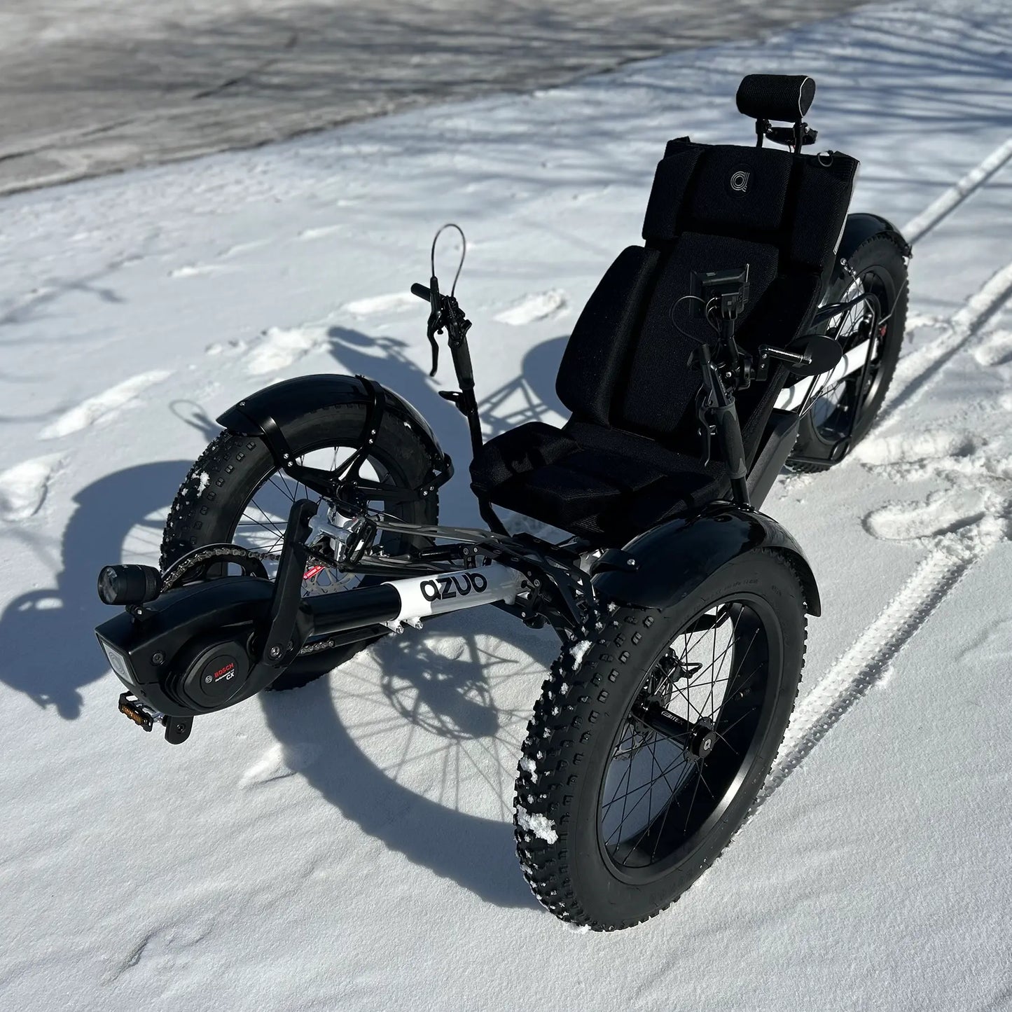 Azub Limited Edition Ti-Fly recumbent trike on a snowy path.