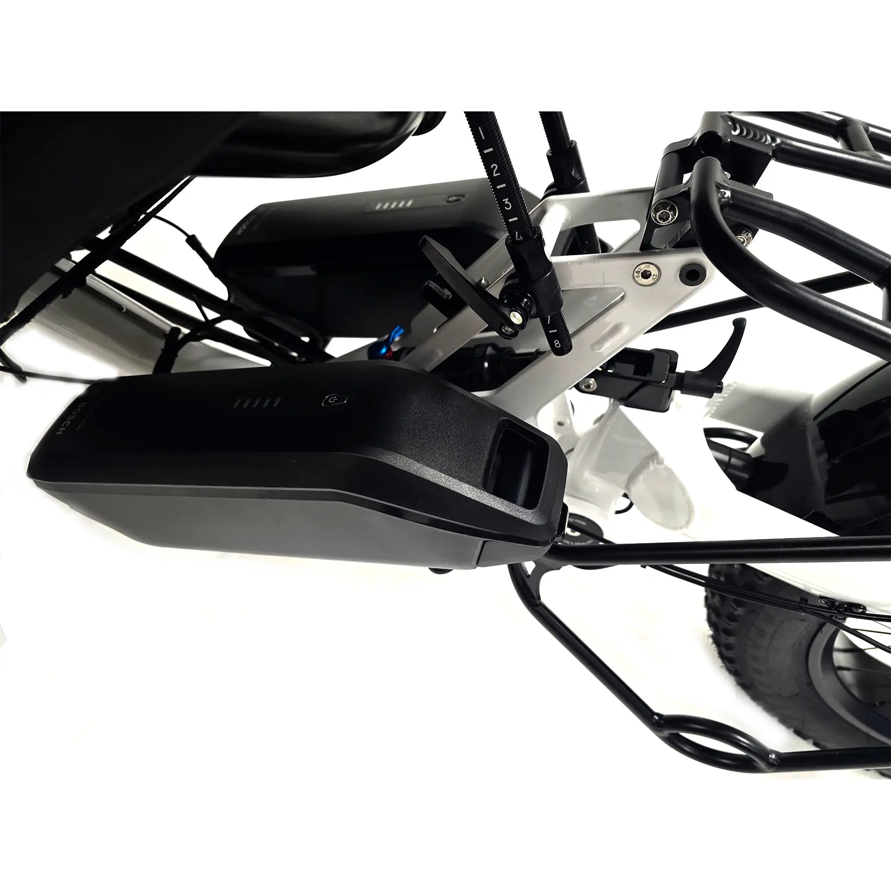 Closeup view of the dual Bosch 800Wh batteries on the Azub Limited Edition Ti-Fly X Bosch Performance CX with Rohloff E14 Shiny White Recumbent Trike against a white background.