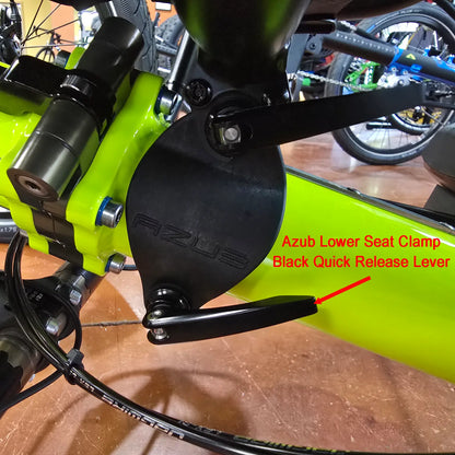Side view of the Azub Lower Seat Clamp Black Quick Release Lever mounted on a yellow recumbent trike.