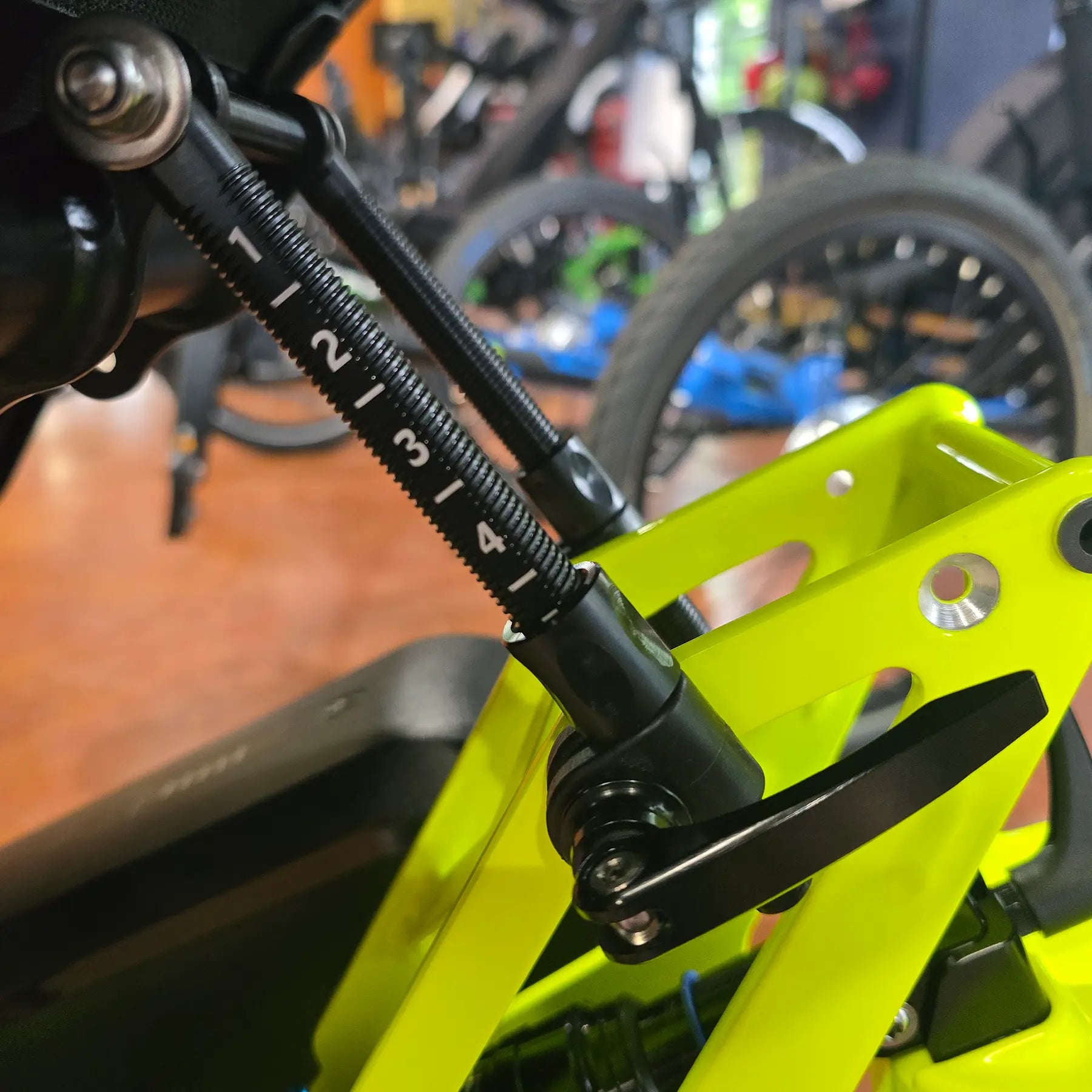 Side view of the Azub Seat Stay Black Quick Release Lever mounted on a yellow recumbent trike with plastic clamp.