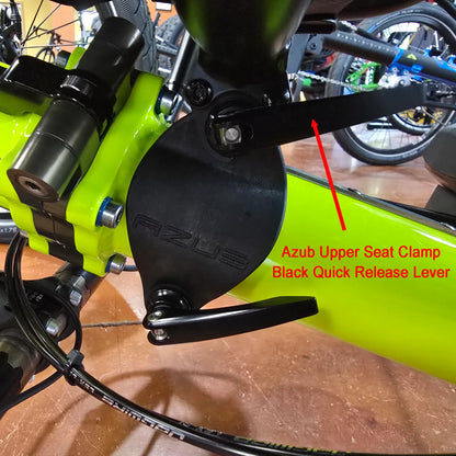 Side view of the Azub Upper Seat Clamp Black Quick Release Lever mounted on the seat clamp on a yellow recumbent trike.