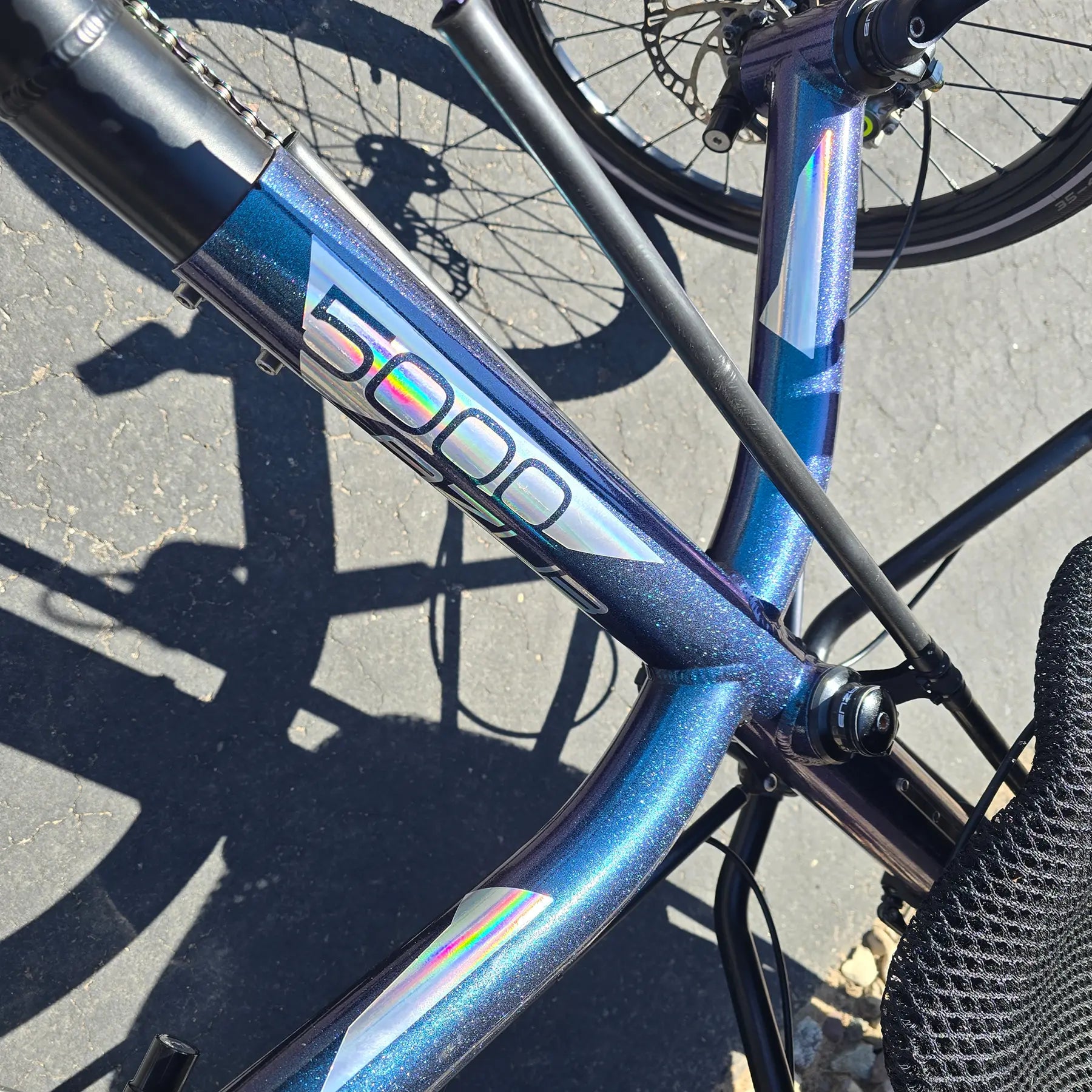 Closeup view of the frame on the Azub Used T-Tris 5000 Chameleon Teal Custom Recumbent Trike in an outdoor setting.