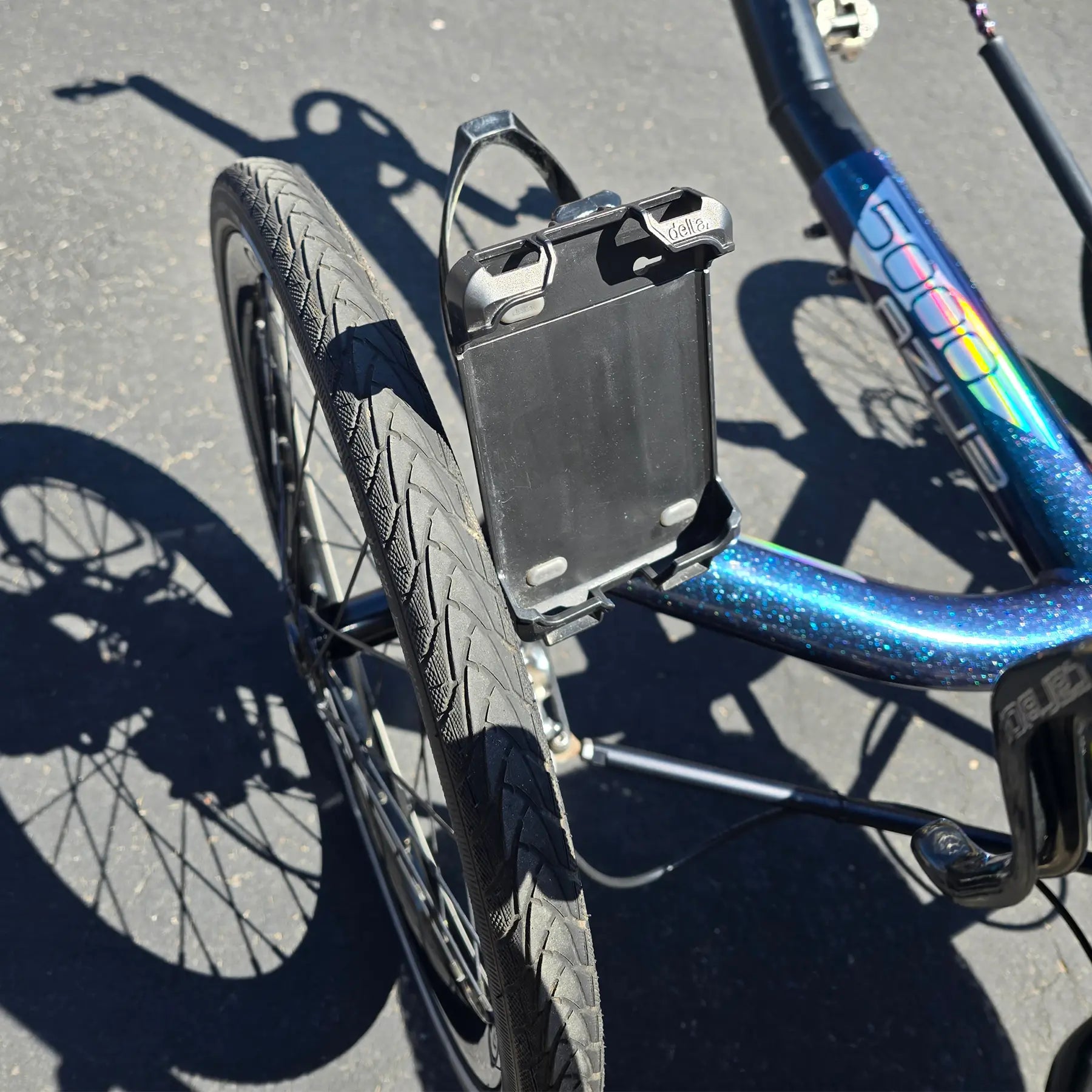 Closeup view of the phone mount on the Azub Used T-Tris 5000 Chameleon Teal Custom Recumbent Trike in an outdoor setting.
