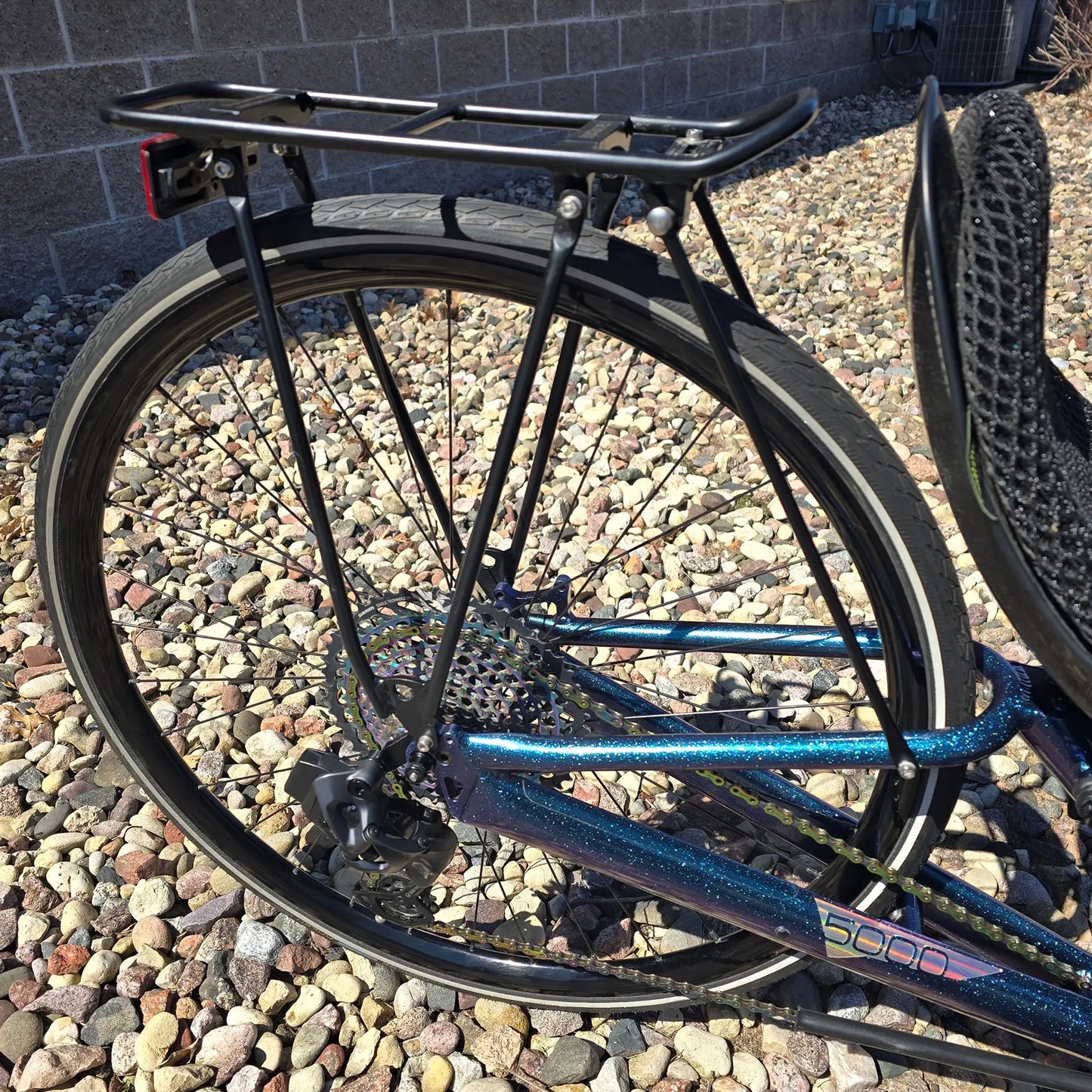 Closeup view of the rear rack on the Azub Used T-Tris 5000 Chameleon Teal Custom Recumbent Trike in an outdoor setting.