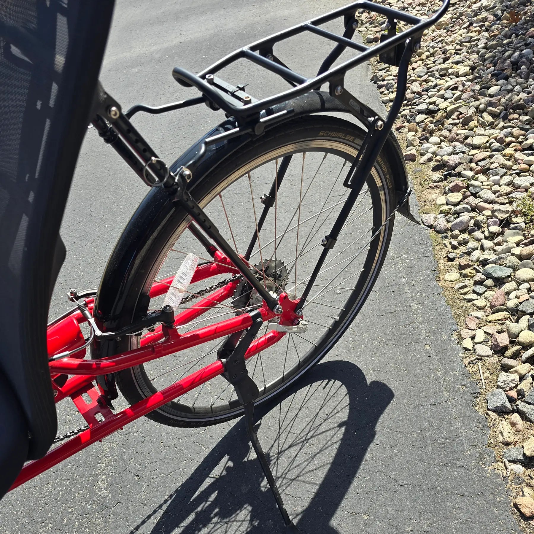 Closeup view of the rear rack and kickstand on the Bacchetta Used Bella Red SM-MD Recumbent Bike in an outdoor setting.