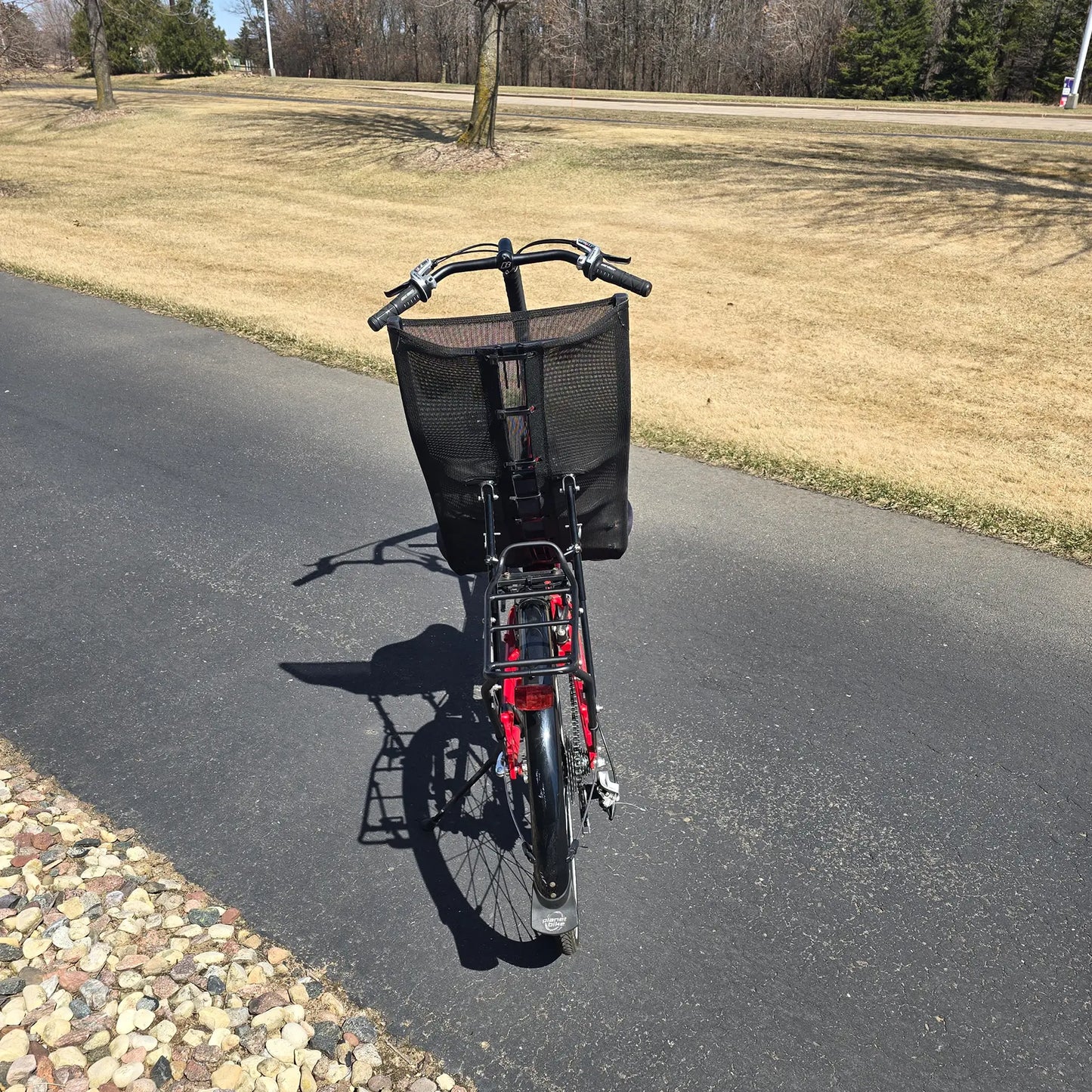 Rear view of the Bacchetta Used Bella Red SM-MD Recumbent Bike in an outdoor setting.