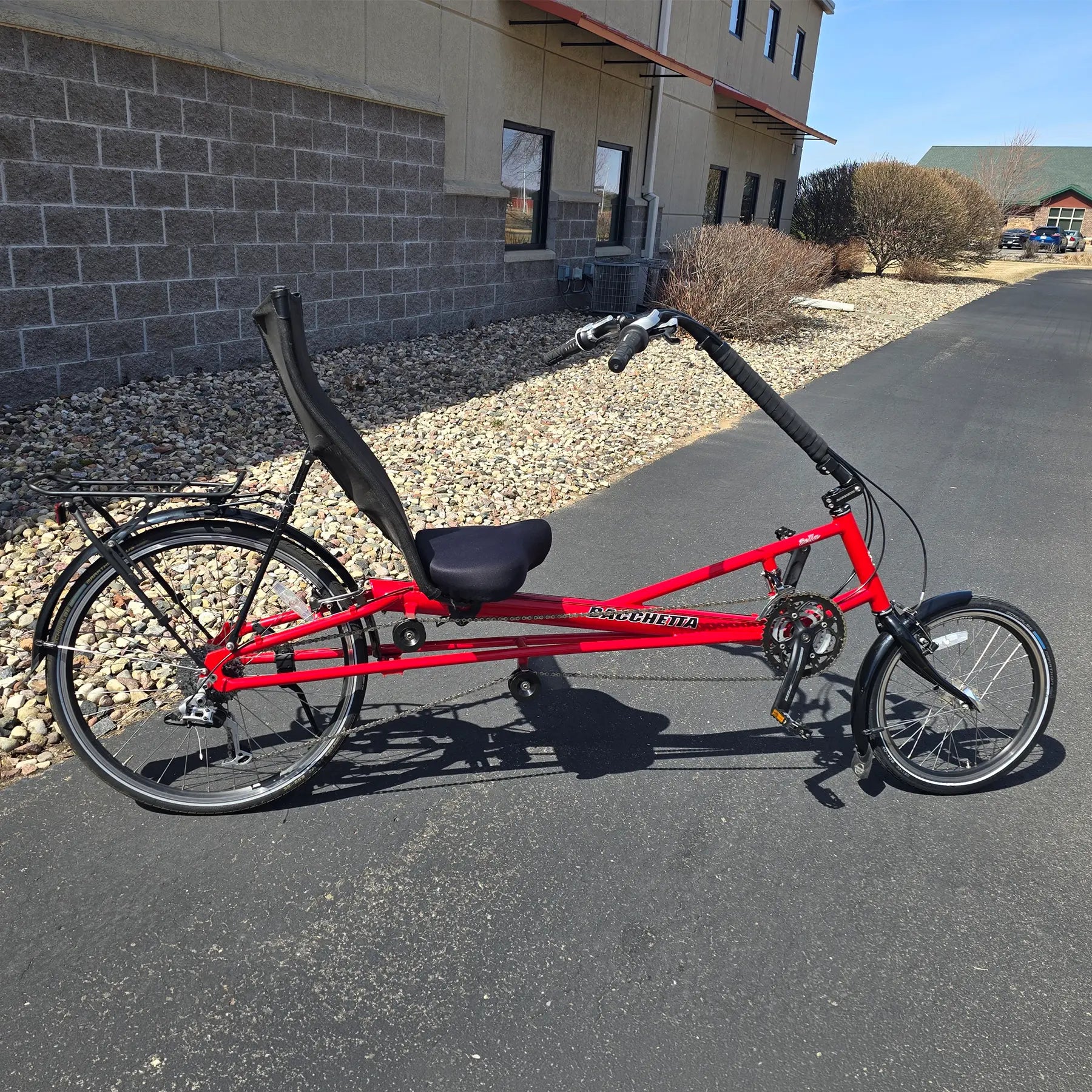 Side view of the Bacchetta Used Bella Red SM-MD Recumbent Bike in an outdoor setting.