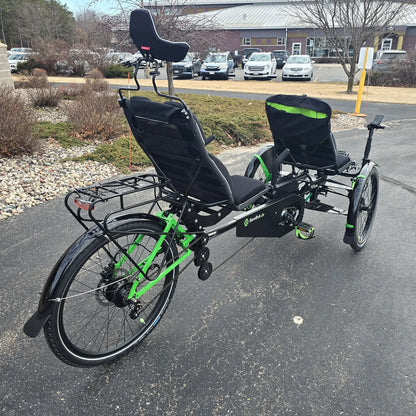 Angled rear view of the BamBuk Independent Bosch Performance CX Recumbent Tandem Trike in the Hostel Shoppe parking lot.