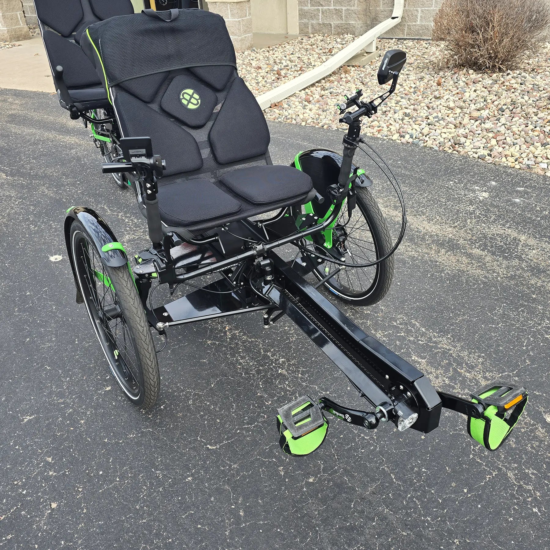 Closeup front view of the BamBuk Independent Bosch Performance CX Recumbent Tandem Trike in the Hostel Shoppe parking lot.