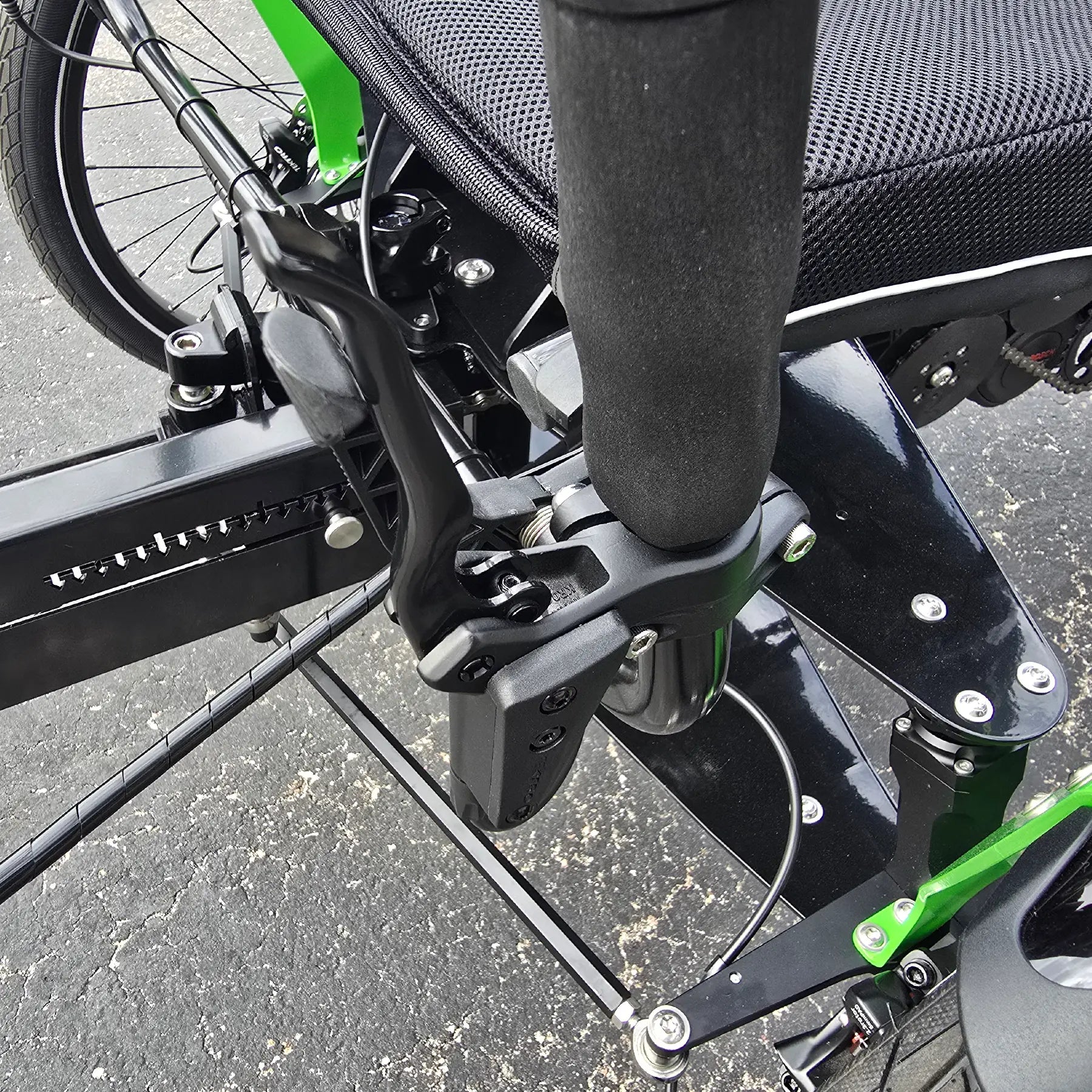Closeup view of the rear locking brake lever on the BamBuk Independent Bosch Performance CX Recumbent Tandem Trike in the Hostel Shoppe parking lot.