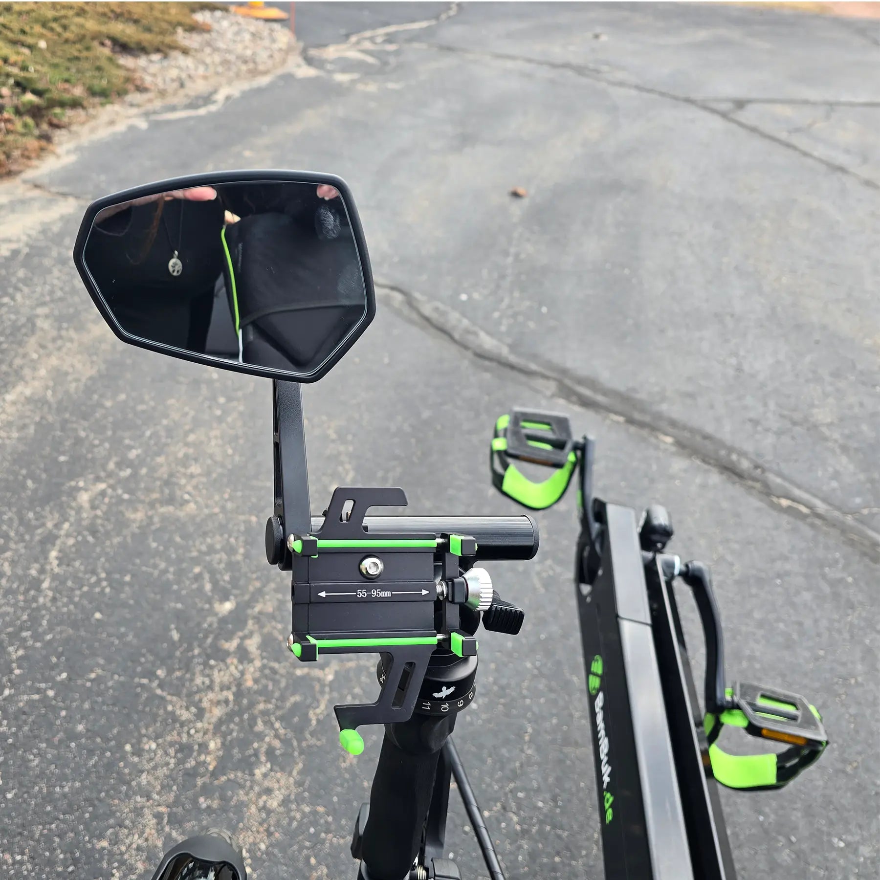 Closeup view of the mirror and the phone mount on the BamBuk Independent Bosch Performance CX Recumbent Tandem Trike in the Hostel Shoppe parking lot.