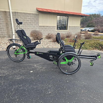 Side view of the BamBuk Independent Bosch Performance CX Recumbent Tandem Trike in the Hostel Shoppe parking lot.