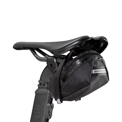 Angled back view of the Bontrager Elite Seat Pack in Black mounted on a bike saddle against a white background.