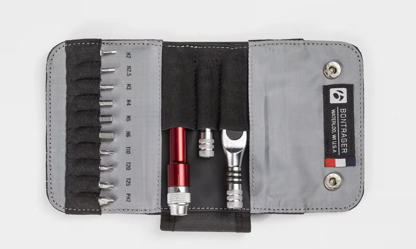 Open Bontrager Pro Ratchet Multi-tool l kit with various tools including a red screwdriver and wrench, on a white background.