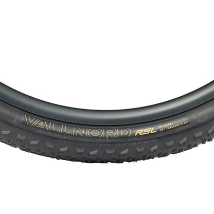 Closeup side profile of the Bontrager Vallnord RSL XR TLR MTB Tire 29 x 2.40 inch (61-622mm) in black against a white background.