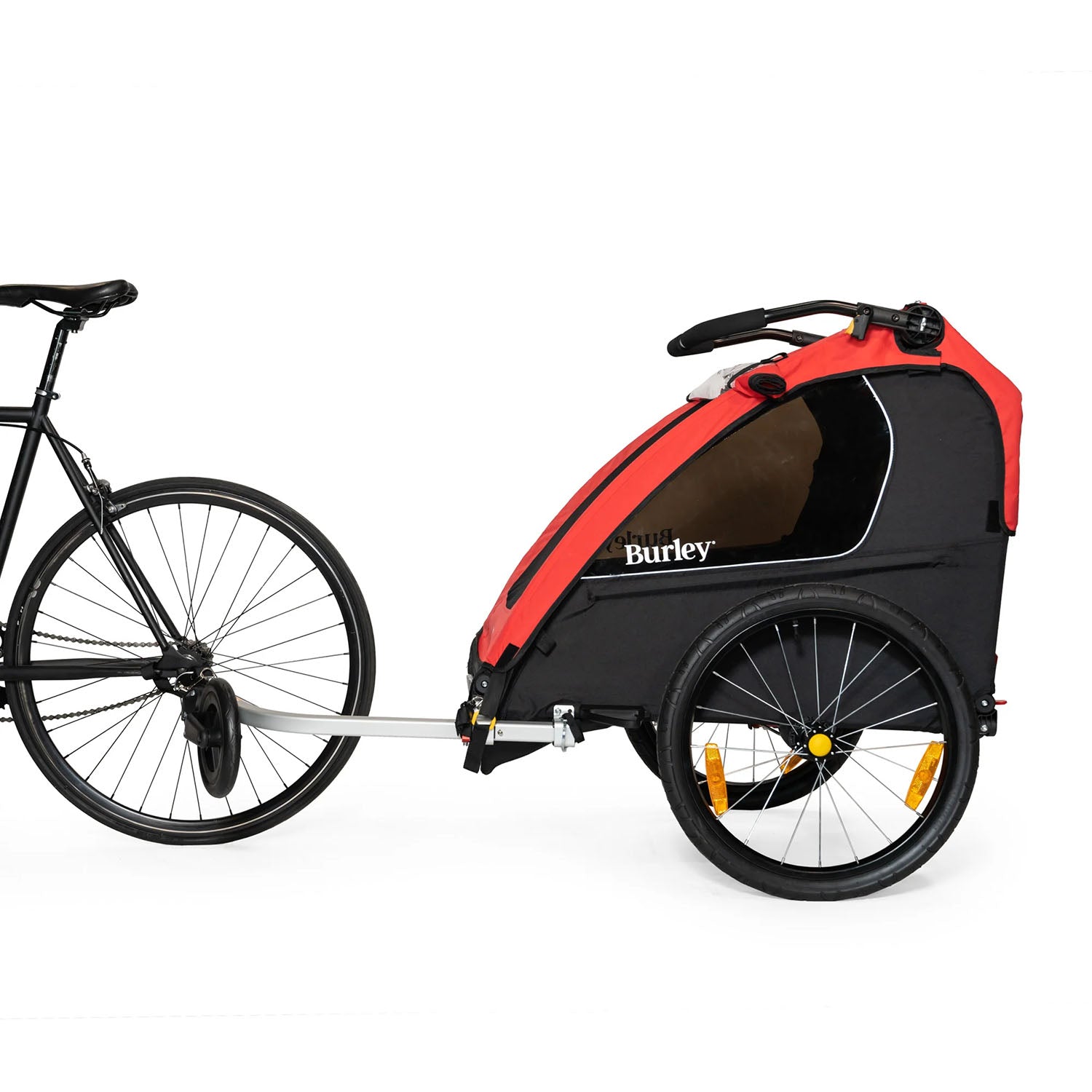 Side view of the Burley Honey Bee Double Child Trailer in Red, mounted to the back wheel of a bike, on a white background.