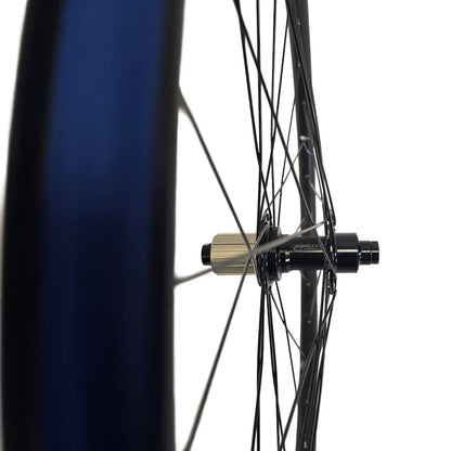 Rim profile of the Catrike 26 Inch Thru-Axle Rear Wheel with blue Rim Tape against a white background.