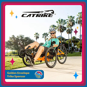 A woman rides an orange Catrike 5.5.9. recumbent trike.