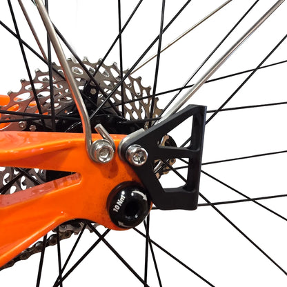 Side view of the Catrike Flag Mount in black mounted on an orange trike against a white background.