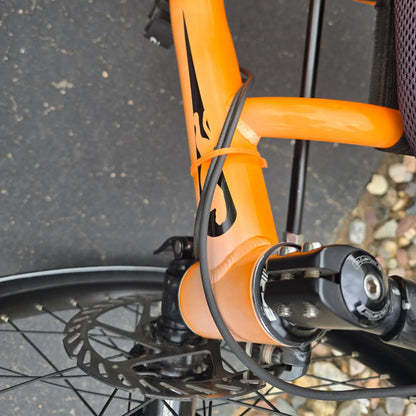 Closeup view of sun fading on the Catrike Used 5.5.9. e-Cat Atomic Orange Recumbent Trike in an outdoor setting.