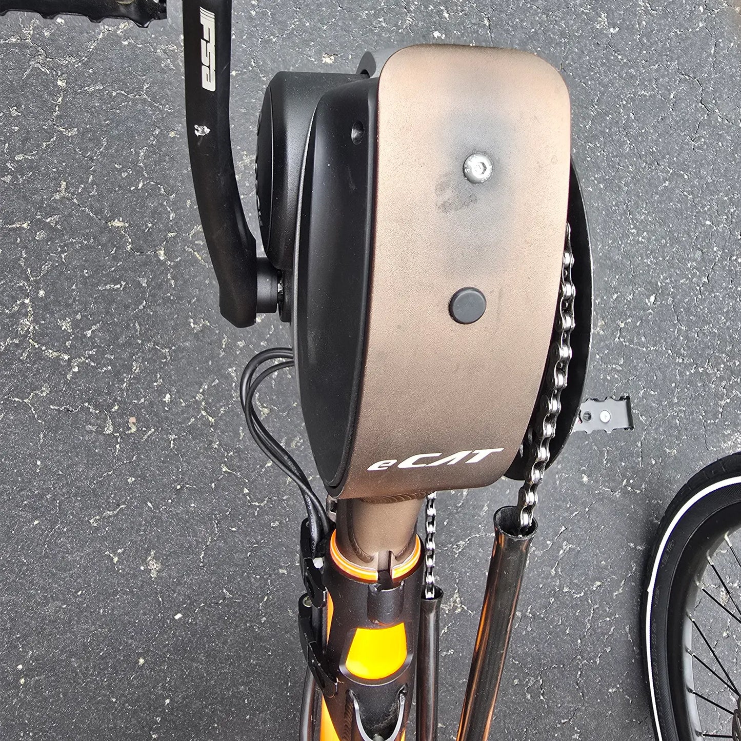 Closeup view of the boom showing sun fading on the Catrike Used 5.5.9. e-Cat Atomic Orange Recumbent Trike in an outdoor setting.