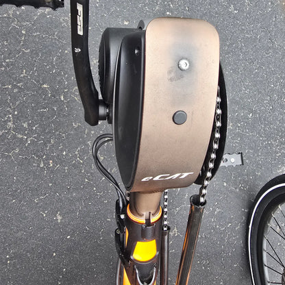 Closeup view of the boom showing sun fading on the Catrike Used 5.5.9. e-Cat Atomic Orange Recumbent Trike in an outdoor setting.