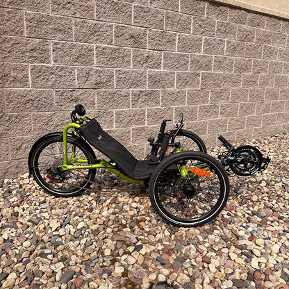 Side view of the Catrike Used Pocket Eon Green Recumbent Trike in an outdoor setting.