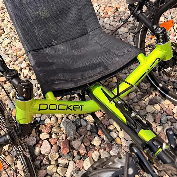 Closeup view of the bottle cage, seat and frame on the Catrike Used Pocket Eon Green Recumbent Trike in an outdoor setting.