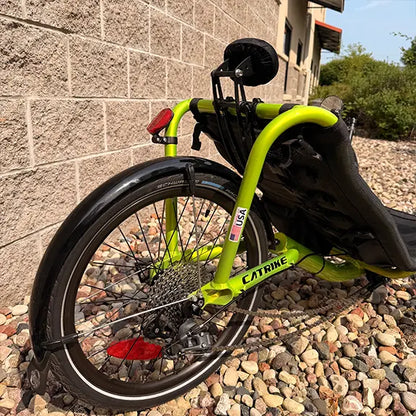 Closeup view of the neckrest, rear fender and wheel on the Catrike Used Pocket Eon Green Recumbent Trike in an outdoor setting.