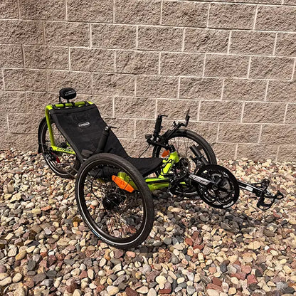 Angled view of the Catrike Used Pocket Eon Green Recumbent Trike in an outdoor setting.
