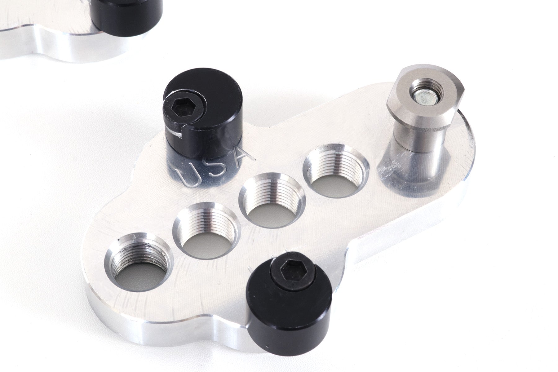 Closeup of a silver CJ Ackley Machine Company Wide Crank Arm Shortener.