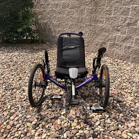 Front view of the Catrike Demo Dumont Compact Candy Purple Recumbent Trike in an outdoor setting.