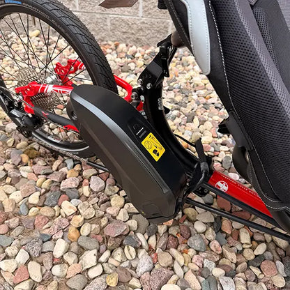 Closeup view of the main battery on the ICE Demo Sprint Pixel RS STEPS EP6 Passion Red Recumbent Trike in an outdoor setting.