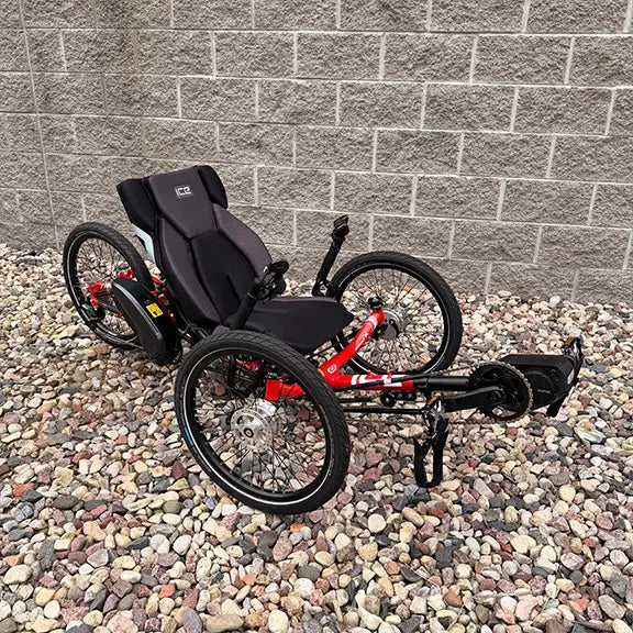 Anlged side view of the ICE Demo Sprint Pixel RS STEPS EP6 Passion Red Recumbent Trike in an outdoor setting.