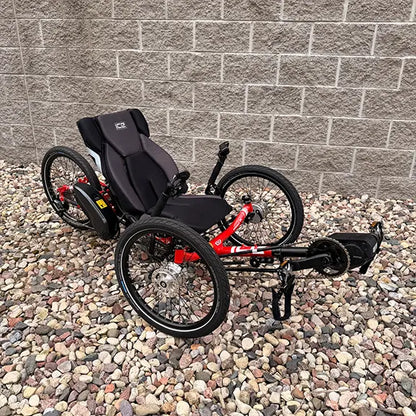 Anlged side view of the ICE Demo Sprint Pixel RS STEPS EP6 Passion Red Recumbent Trike in an outdoor setting.