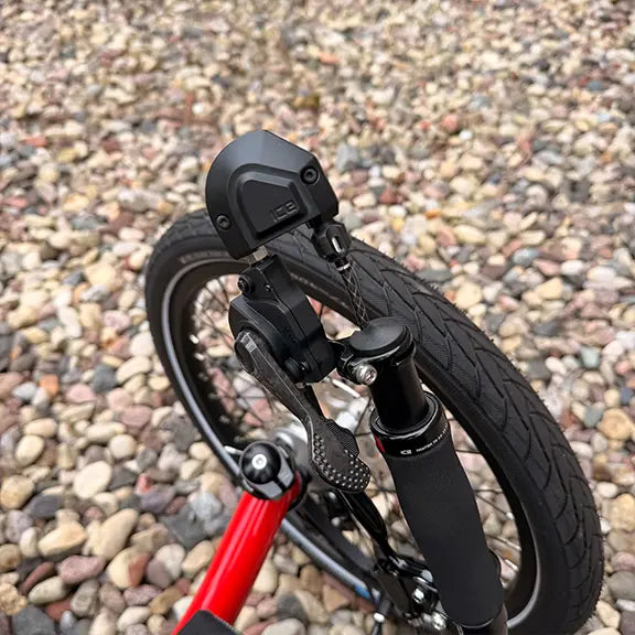 Closeup view of the shifter on the ICE Demo Sprint Pixel RS STEPS EP6 Passion Red Recumbent Trike in an outdoor setting.