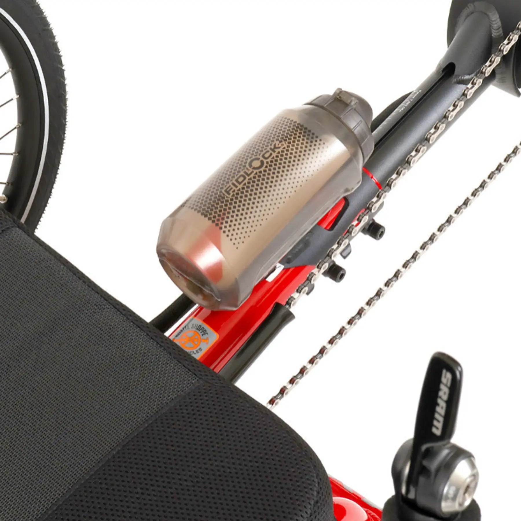 Angled view of the Fidlock TWIST 750 Compact Single Bottle in Smoke mounted on a red recumbent trike against a white background.