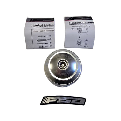 Top profile of the Full Speed Ahead Orbit X 1 inch Threadless Headset in silver with sticker and directions against a white background.