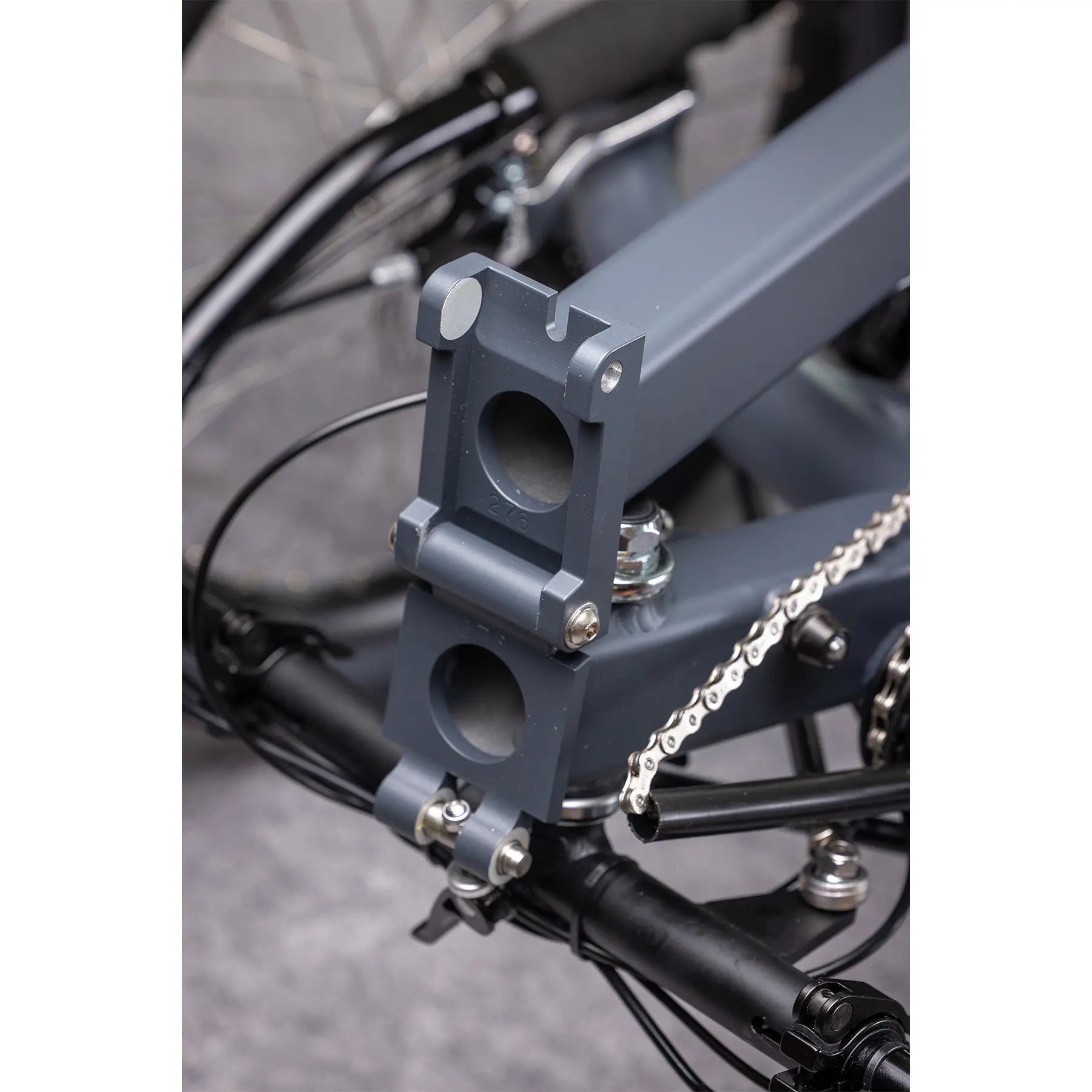 Closeup view of the folding hinge on the Greenspeed Magnum XL Bosch e-Plus Recumbent Trike in Smoke against a grey background.