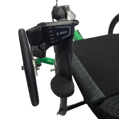 Closeup view of the Bosch controller and ATC grips on the Greenspeed Magnum XL Bosch e-Plus Recumbent Trike in Speed Green against a white background.