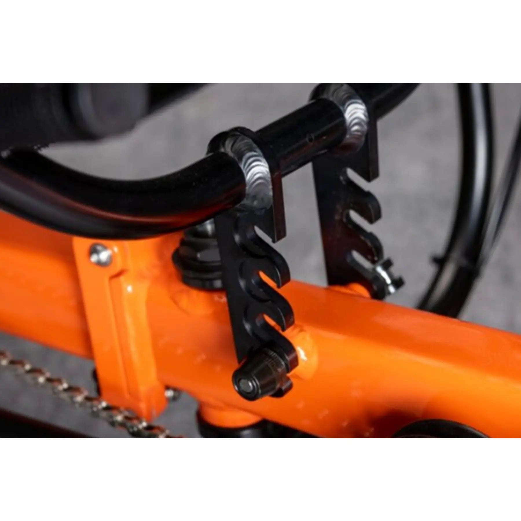 Closeup view of the Greenspeed Magnum XL Recumbent Trike in Tangerine Dream seat hieght adjustment against a grey background.