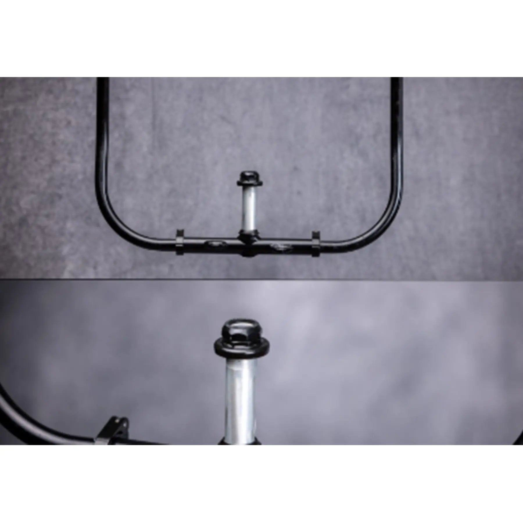 Closeup view of the Greenspeed Magnum XL Recumbent Trike handlebars against a grey background.