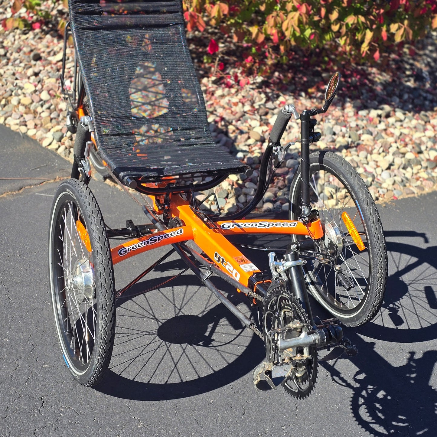 Front closeup view of a used Greenspeed GT20 in orange in an outdoor setting.