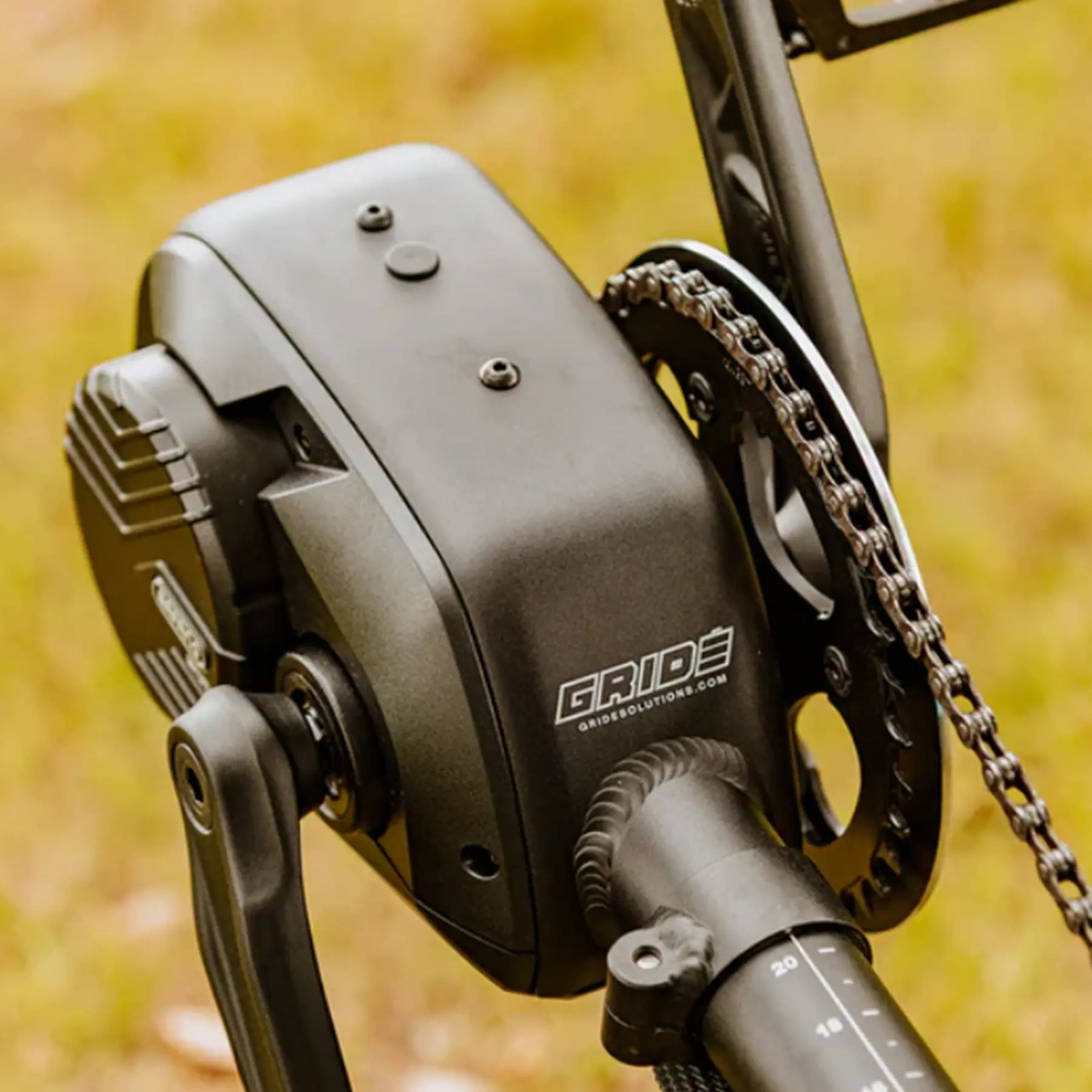 Closeup view of motor on the GRIDE Solutions GXT Plus E-Trike Drive System for 20 inch Rear Wheels mounted on an ICE trike in an outdoor setting.