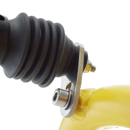 Image of some of the parts in the Hase Direct Connection for Weber Hitch connecting a weber hitch and a yellow Hase trike against a white background.